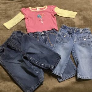 3 pairs of girls blue jeans and one long sleeve top.